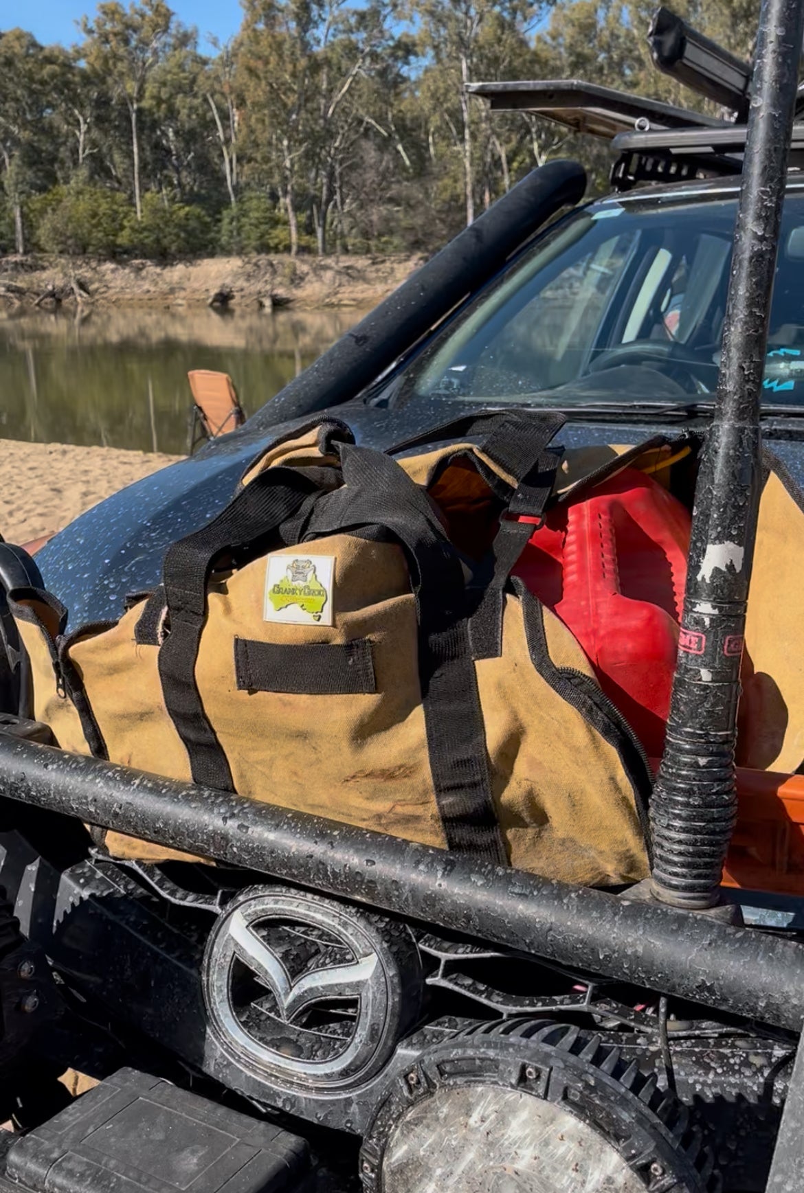 wood bag being used as a chainsaw bag on a ute bullbar in a camping setting