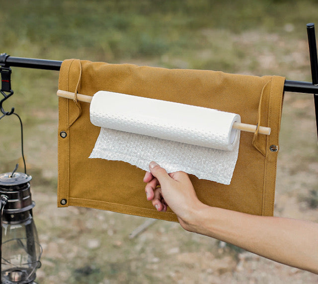 Image of a person using paper towel holder on Kitchen Buddy.