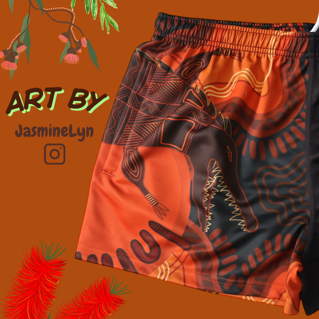 Orange indigenous Aussie Footy Shorts with an orange background, featuring 'Art by JasmineLyn' text.