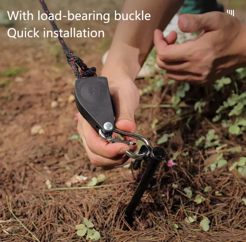 Man using buckle for quick installation of tie downs for a tent or awning. with a bush-land background