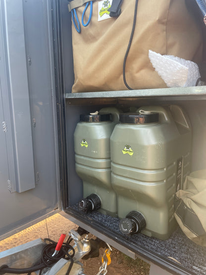 Two green water drums in ute canopy or toolbox 