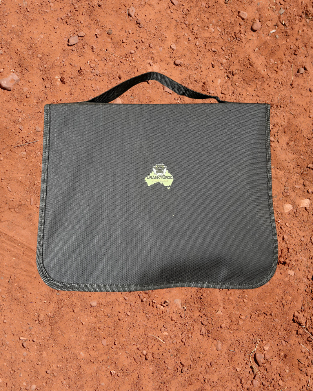 Camping Utensil Set for your camp kitchen in a black carrying case on a red dirt background.