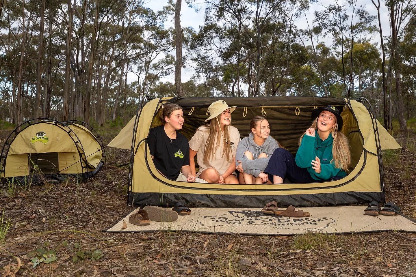 Group of young woman sitting in swag wearing Folding Pouch Hats 