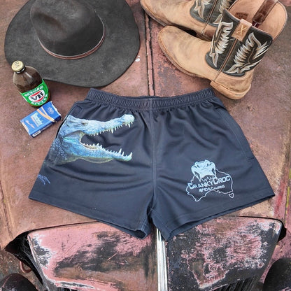 Black Country Aussie Footy Shorts on a 4wd bonnet next to a pair of country boots, country cowboy hat and a beer.