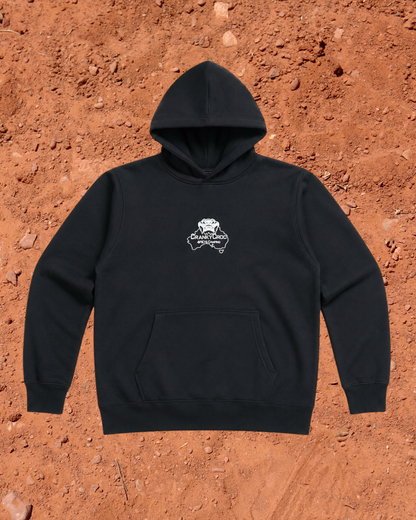 Front view of black hoodie with a white embroidered Cranky Croc logo on a red dirt background