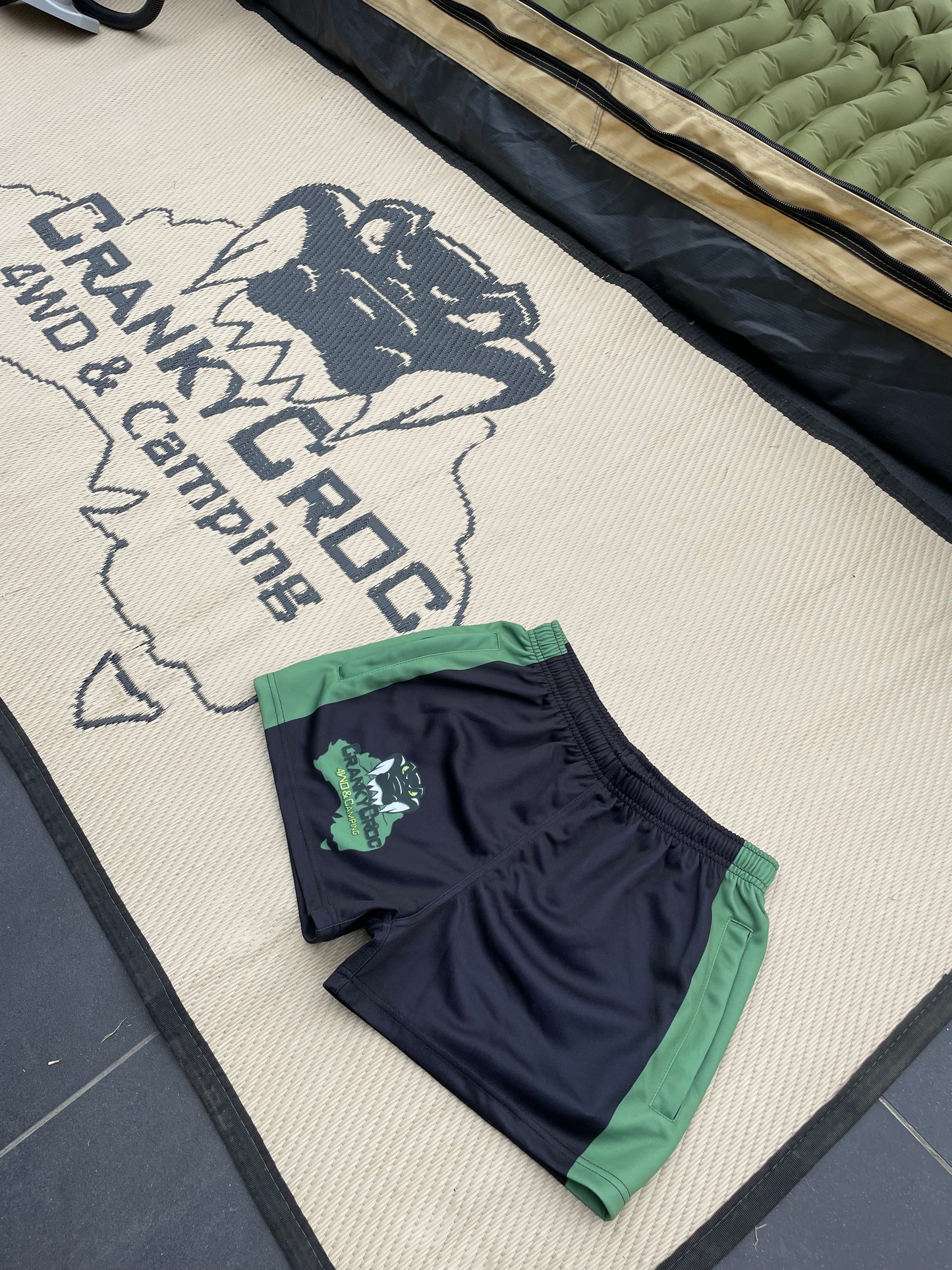 Black with green Aussie Footy Shorts on a Cranky Croc branded matt