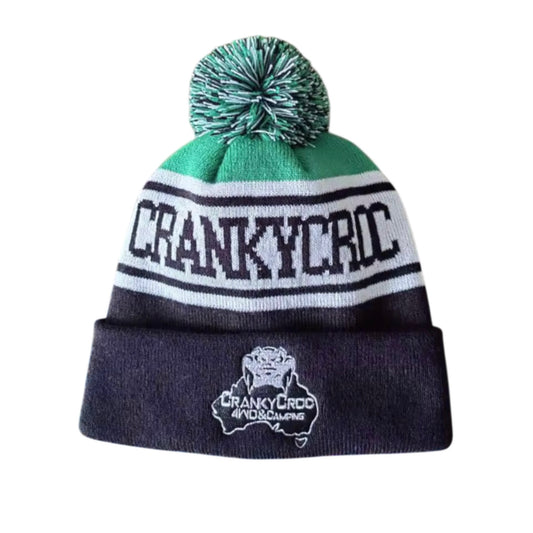 Front view of a Black and Green Beanie with pom-pom and 'Cranky Croc' branding on a white background.