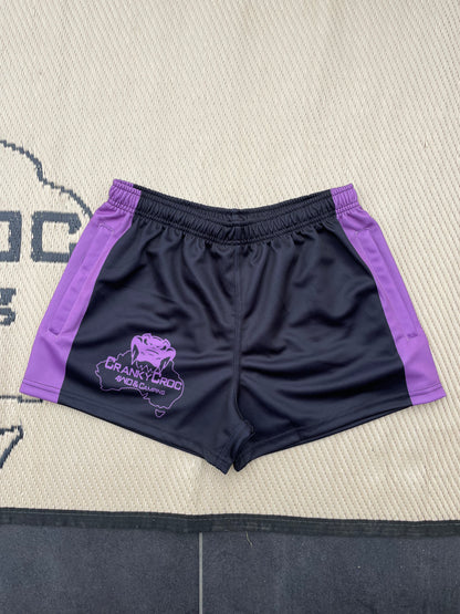 Black with purple Aussie Footy Shorts accents on a textured surface