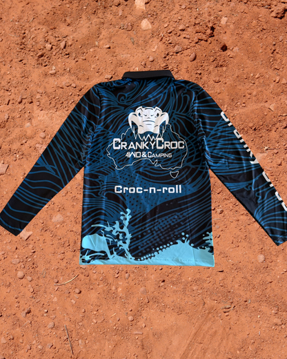 Blue kids long sleeve fishing shirt with 'Cranky Croc' branding on a red dirt background
