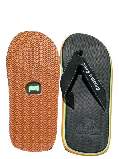 A pair of Cranky Croc Great Aussie Pluggers top and bottom – top of pluggers are black and front are brown with wave texture. Bottom of thongs with Bottle Opener.