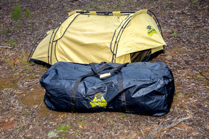 Dundee King Single Swag and PVC Swag Bag in a bush land setting