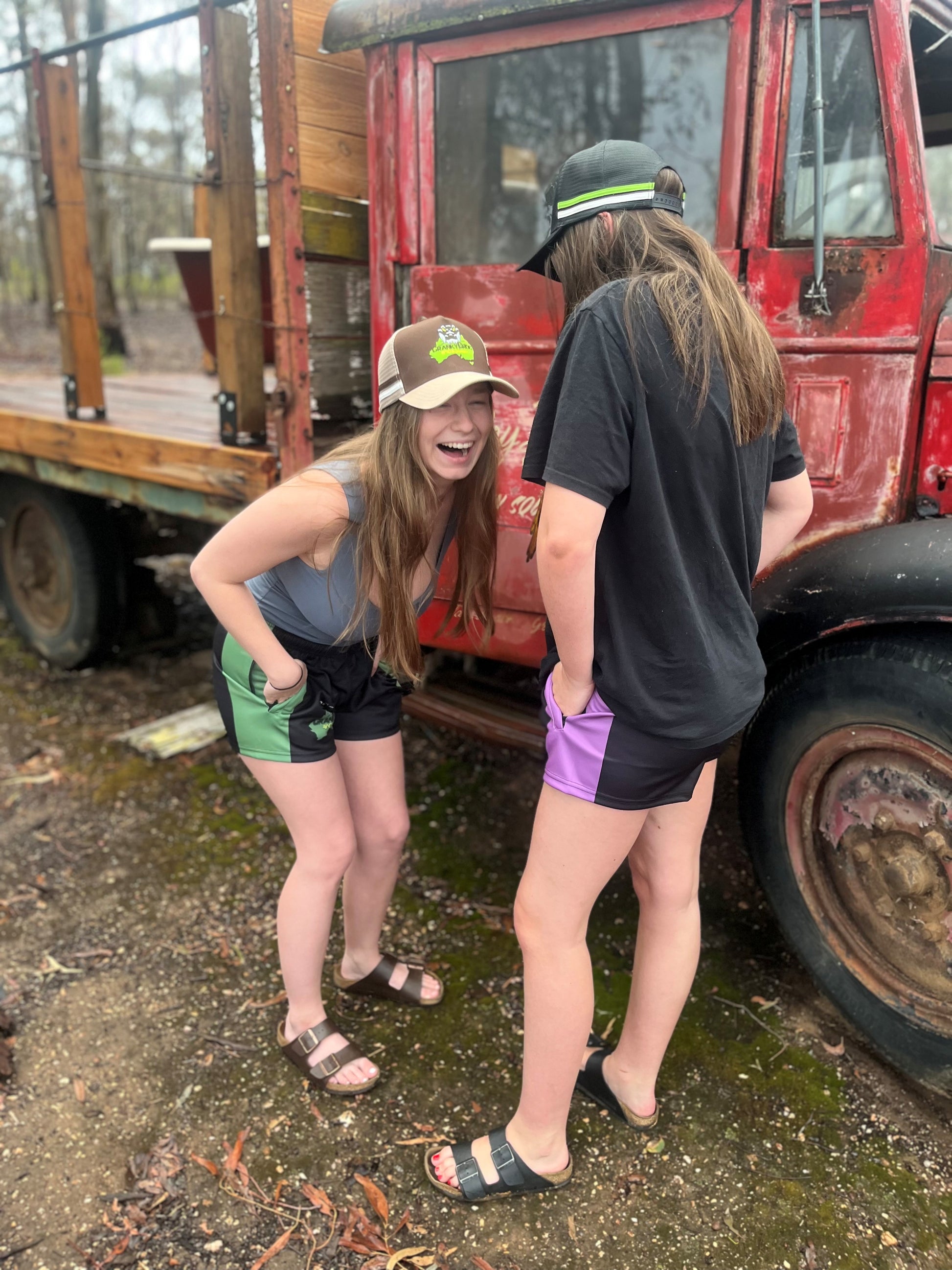 Two girls laughing while wearing Aussie Footy Shorts