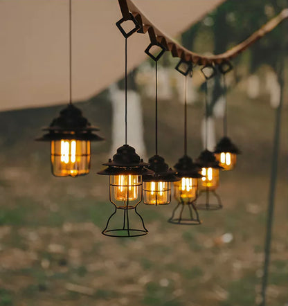 Image of multiple Rechargeable Outdoor Lanterns hanging by a tent rope.