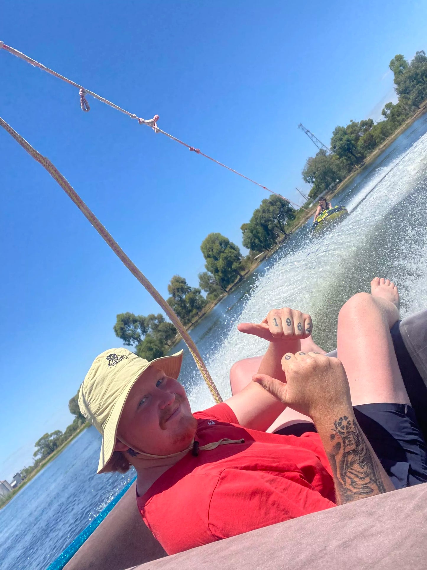 Young man in speed boat wearing Folding Pouch Hat 