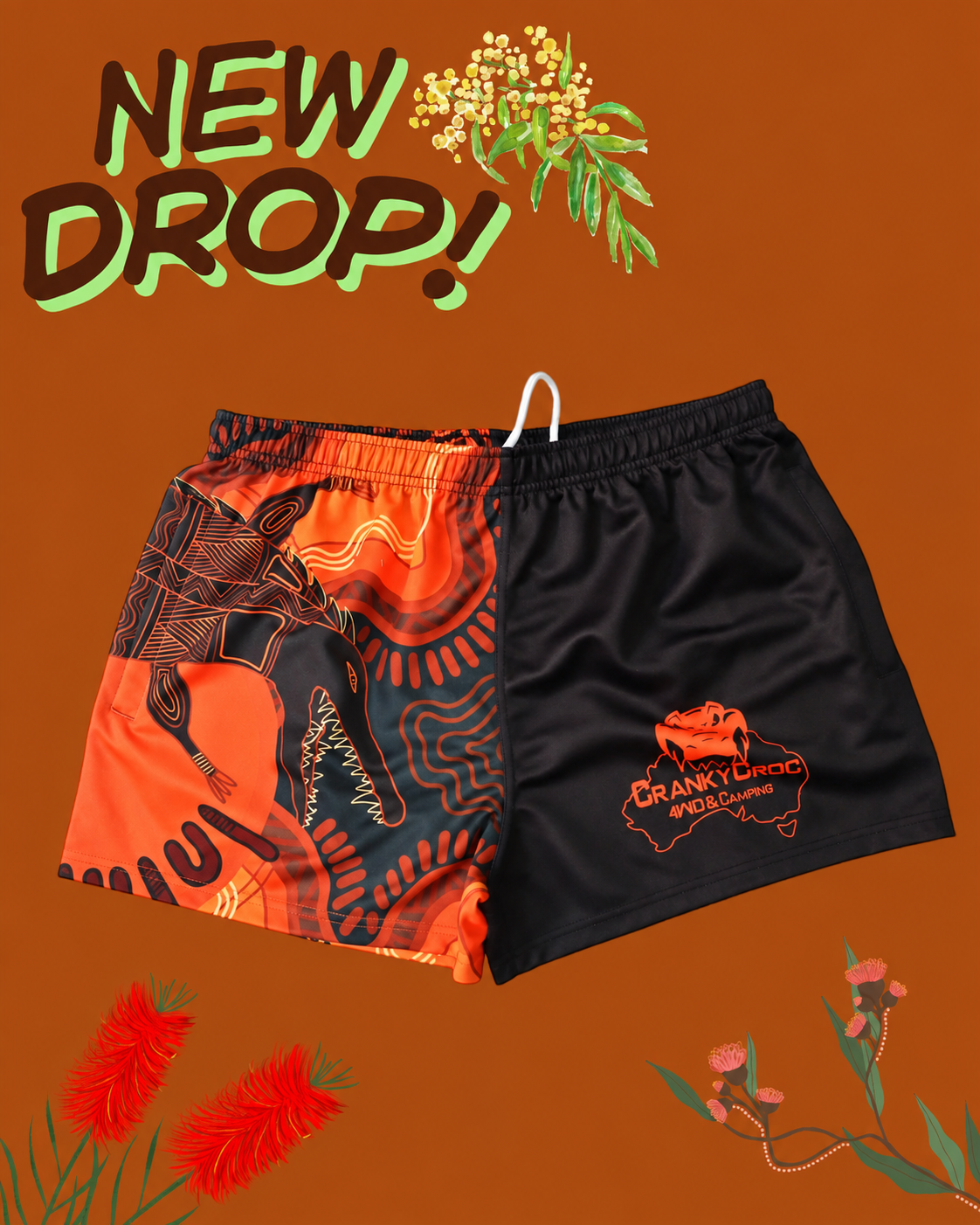 Pair of indigenous art footy shorts on an orange background with floral elements and 'NEW DROP!' text.