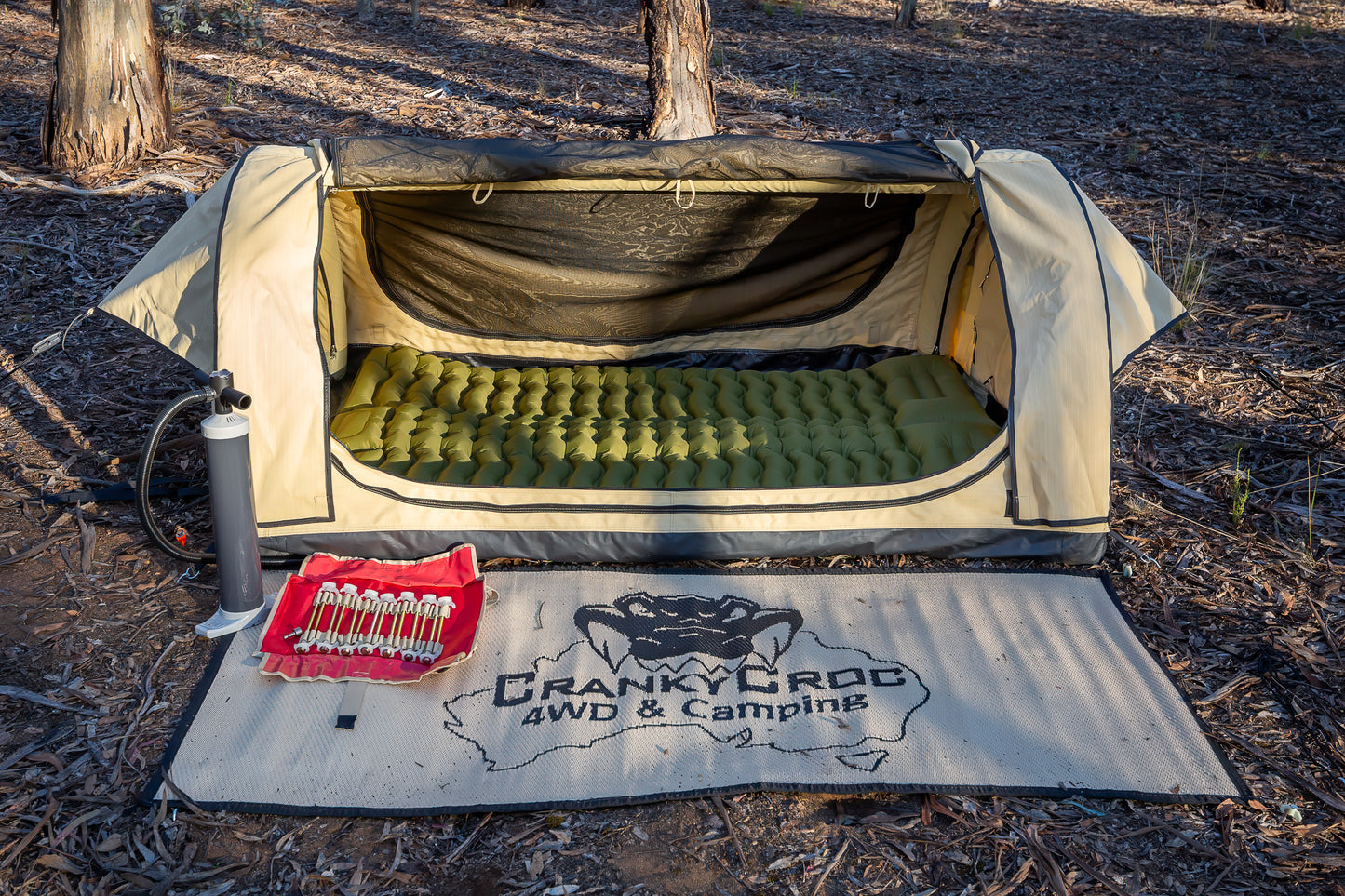 Inflatable swag in bushland with Swag Mat and 'Screw in tent peg' set