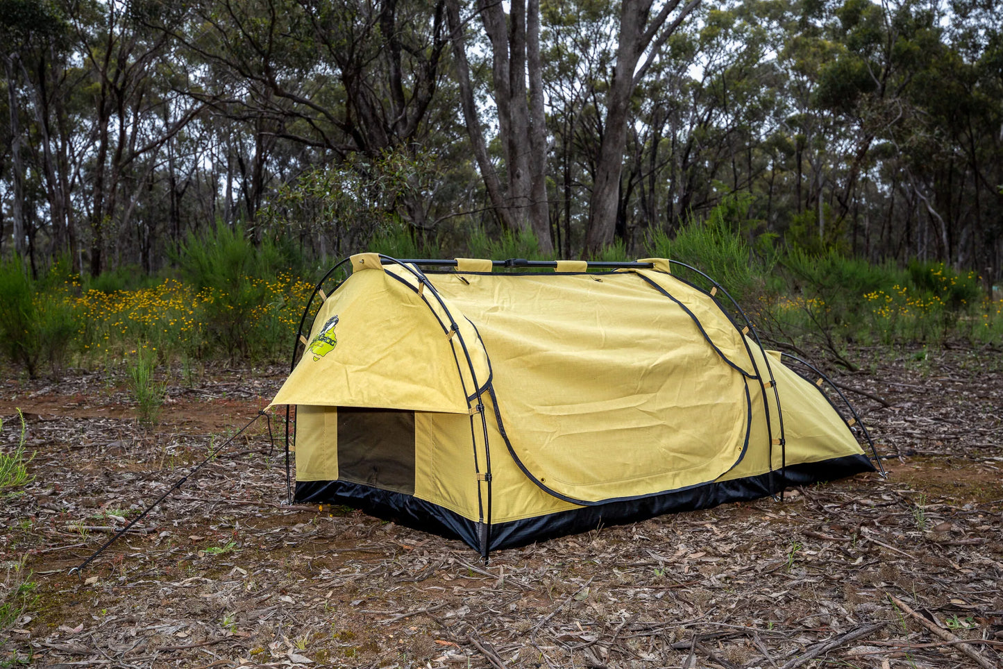 Dundee king single swag in a camping scene in Aussie bushland