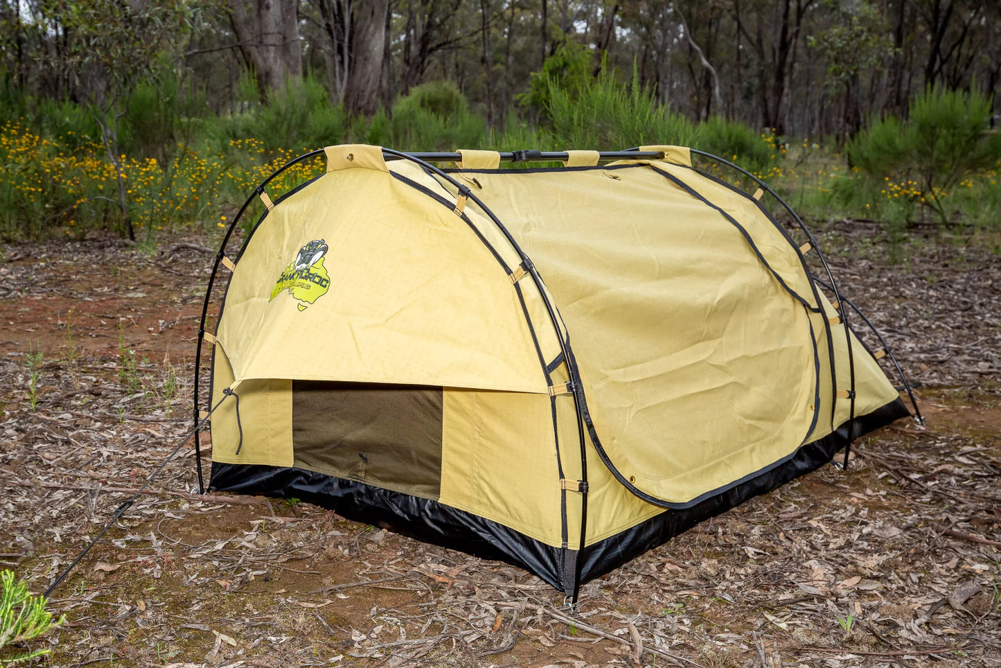 Deluxe swag set up in bushland. The king single swag is fully zipped up.