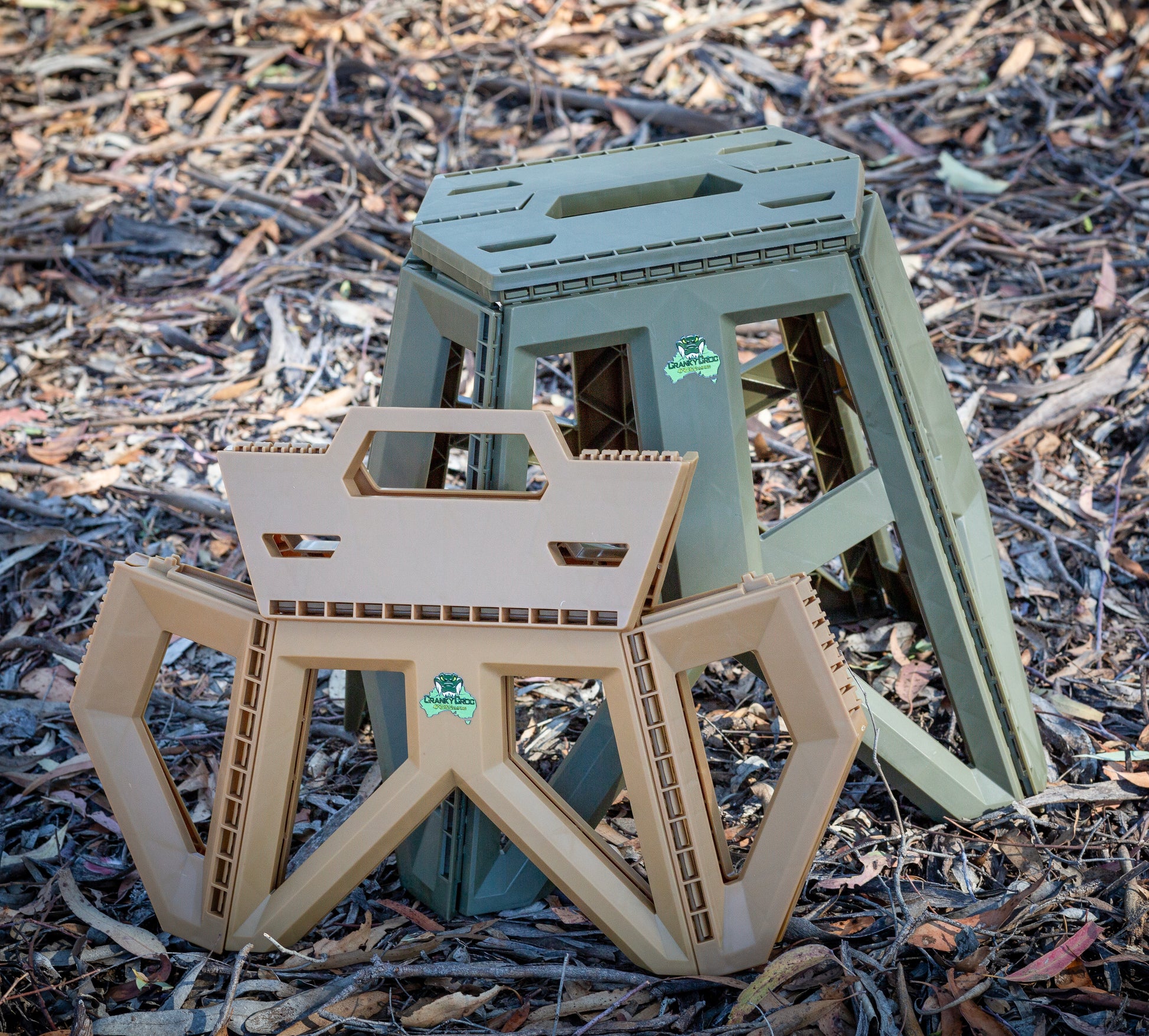 Image of both a small sized and large sized Quickie Folding Step Stool in bushland.