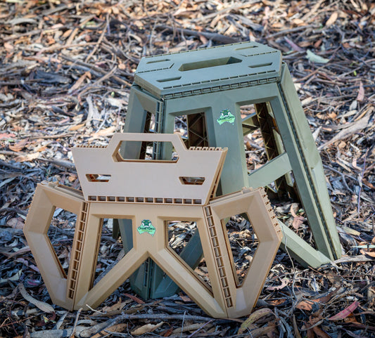 Image of both a small sized and large sized Quickie Folding Step Stool in bushland.