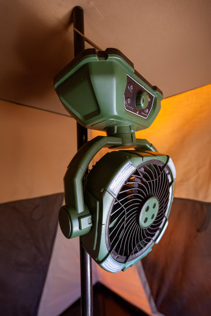 Camping misting fan hanging in a tent. The camping fan is coloured green