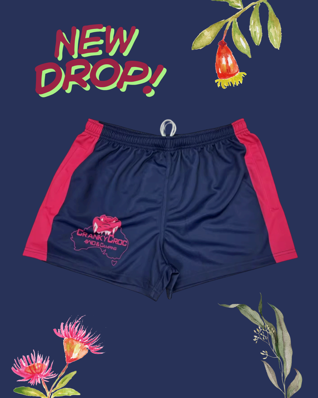 Navy blue Aussie Footy Shorts with pink sides on a dark blue background with floral and leaf decorations.