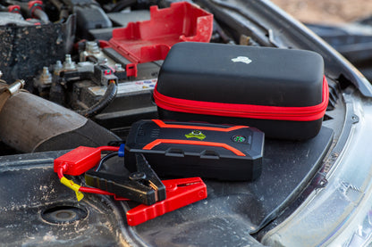 Jump Starter with protective case sitting on 4WD engine, battery jump starter is Cranky Croc branded