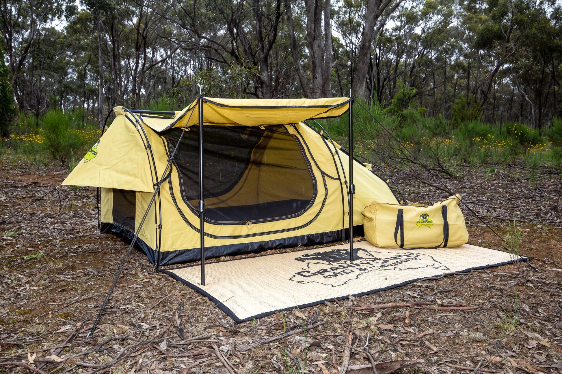 Multi purpose canvas bag and swag mat sitting from of a Dundee swag with awning setup.