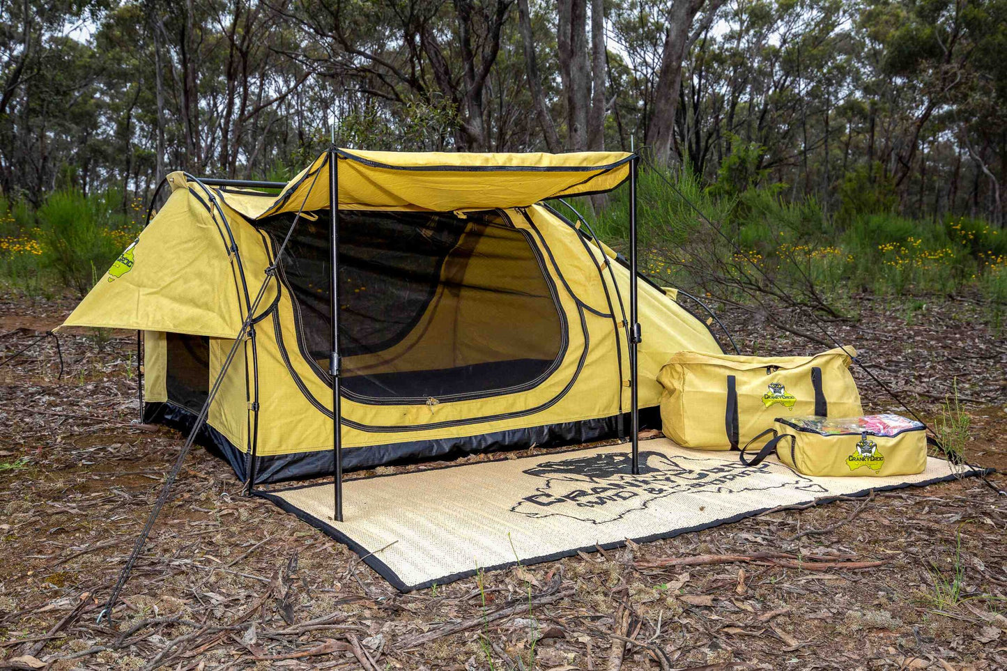 Swag setup in bushland with awning and swag mat set up.