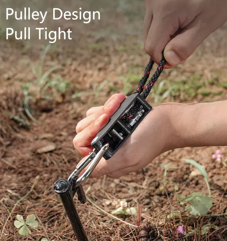 Person tightening tie down ratchets. With bush-land background