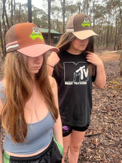 Two woman wearing Brown Trucker Caps in bushland