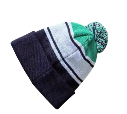 Back view of black with green pom pom beanie on a white background.