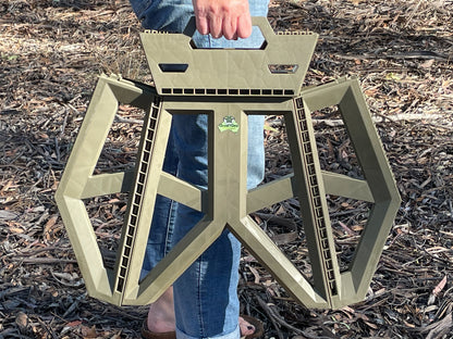 Image of a person using built in handle to easily carry Quickie Foldable Step.