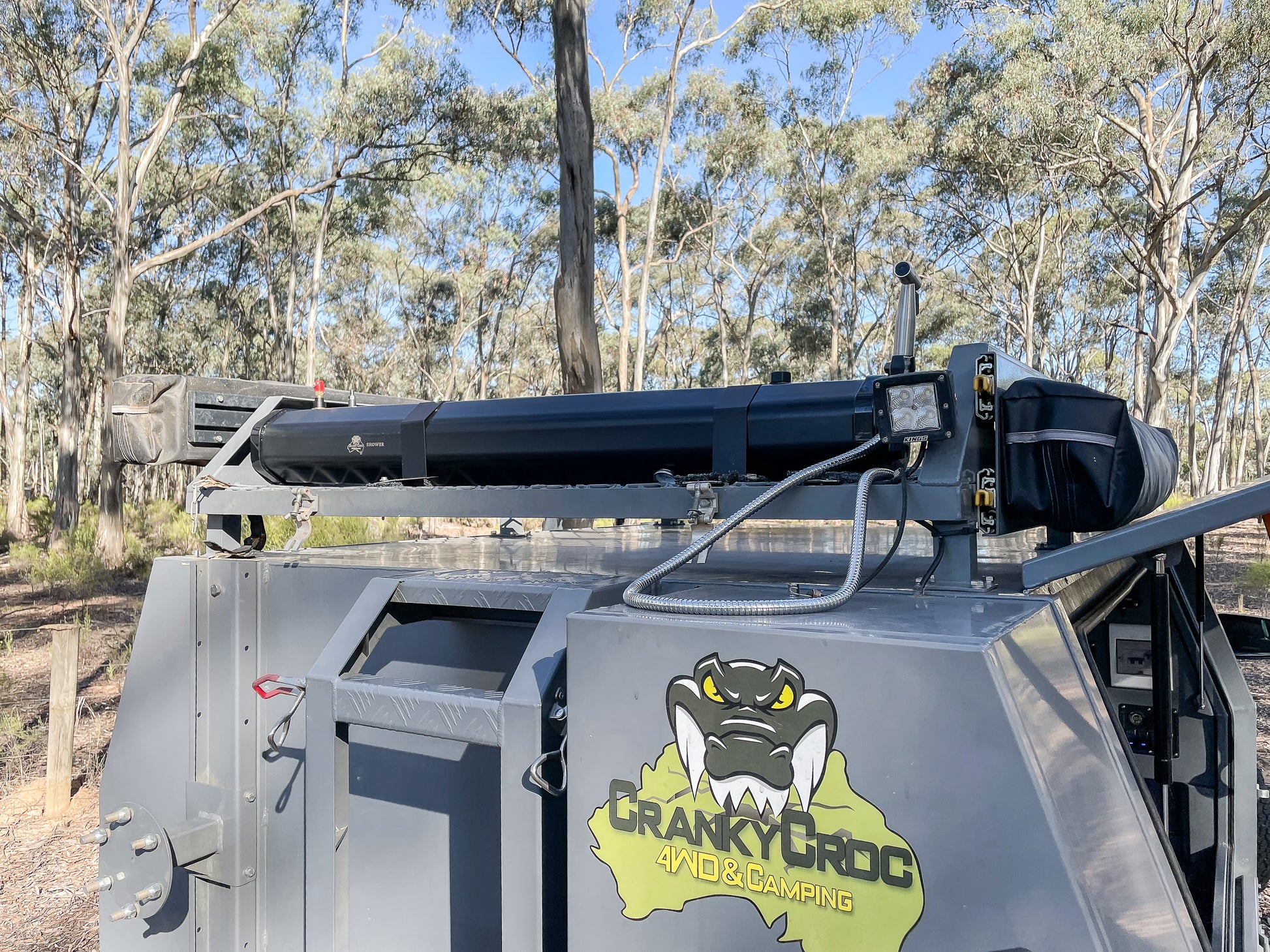 Image of Rooftop Shower System mounted to a roof rack on 4WD ute. 