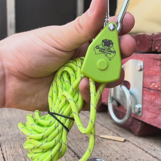 Video of a man tightening a green Cranky Croc branded ratchet tie down straps. The man is demonstrating how to tighten and losen the green tie down straps