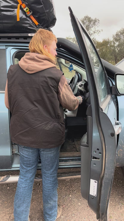 Man using Cranky Crocs Portable Lithium Jump Starter on flat battery. Jump starts car easily