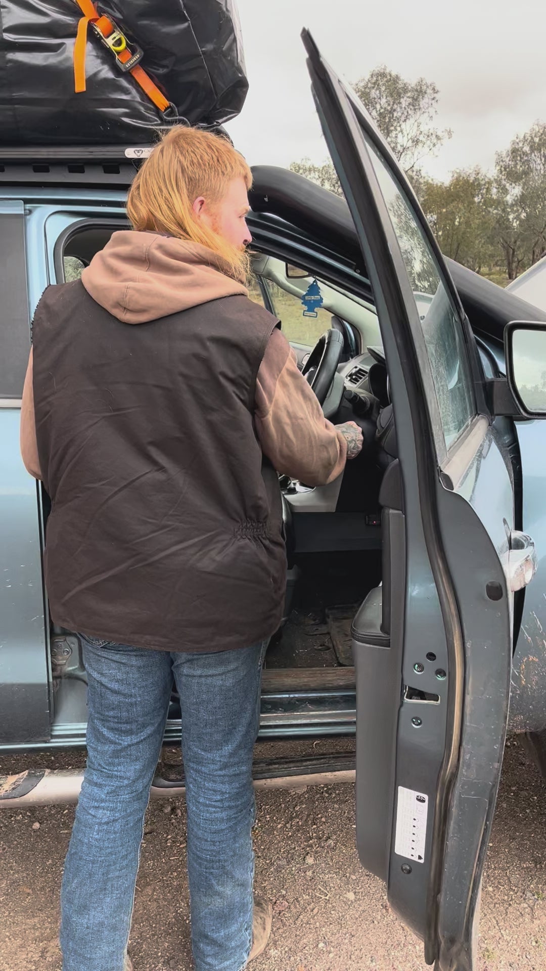 Man using Cranky Crocs Portable Lithium Jump Starter on flat battery. Jump starts car easily